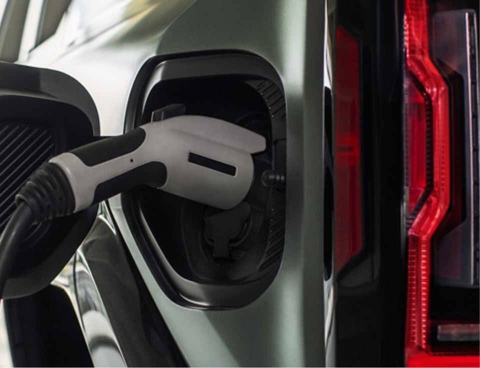Close up of charging port with charger plugged in on a GMC Hummer EV SUV - Shortline Buick GMC in Aurora CO