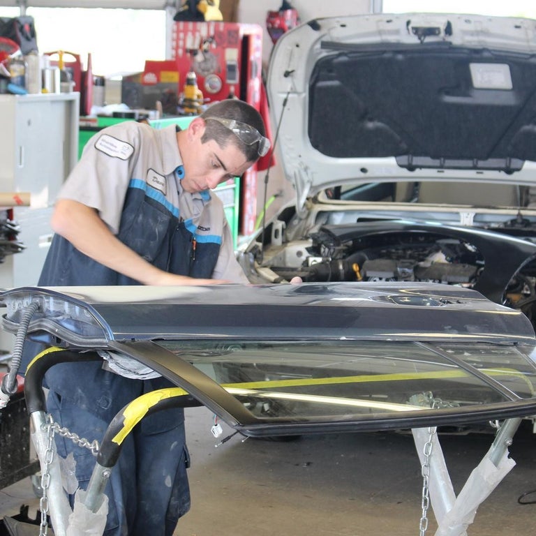 Collision Specialist working on a vehicle door