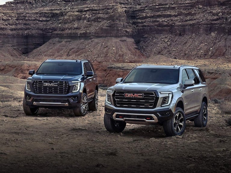 The 2025 GMC Yukon and Yukon XL SUVs Parked in the Desert