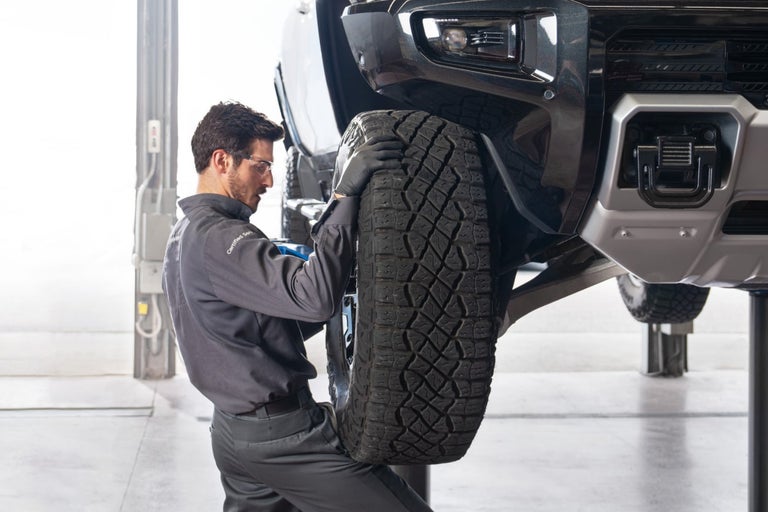 A Certified Service Professional working on a wheel